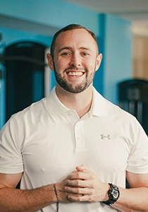 Jacob Weaver smiling in a white shirt.